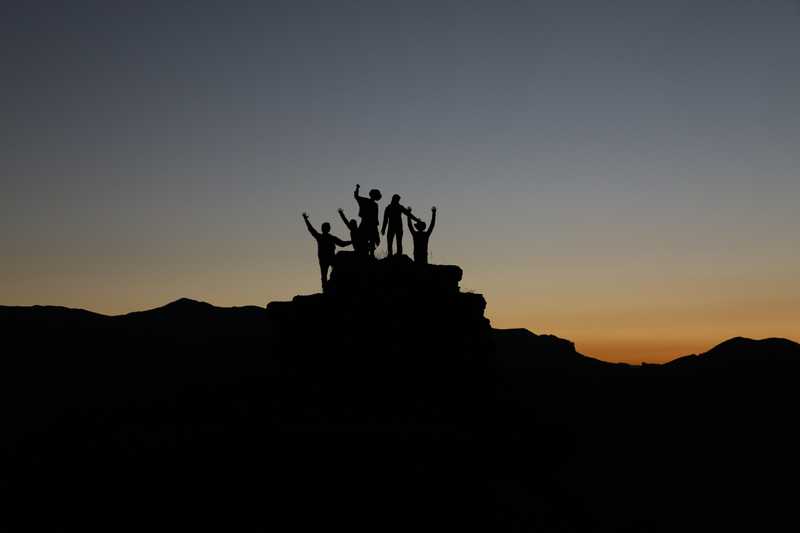 Silhouette of people at sunset on a mountain
